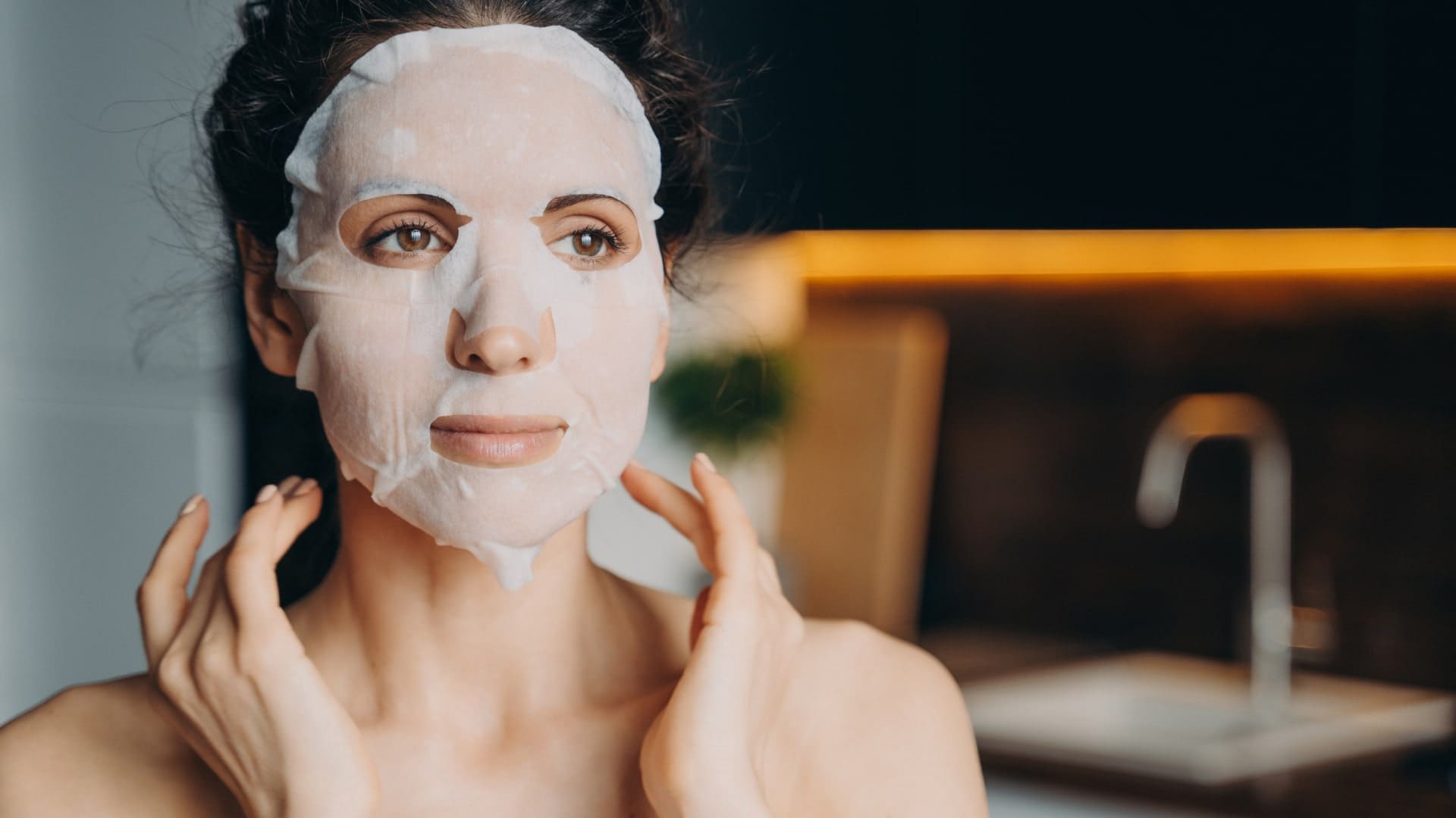 Woman wearing Invity SuperNAD Youth Activating Facial Sheet Mask